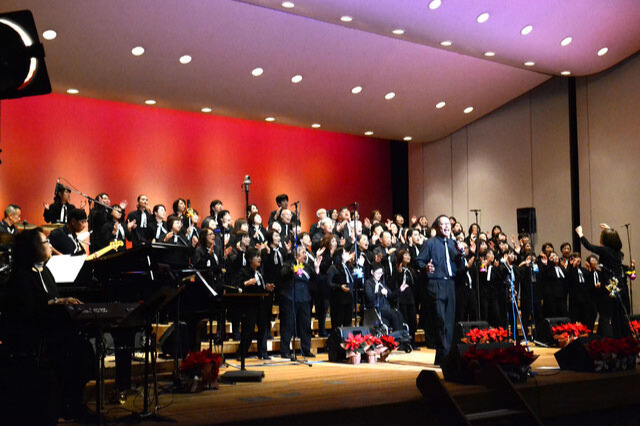 In the concert hall, around 90 members of the gospel choir are singing in harmony.